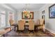 Formal dining room featuring an ornate chandelier, a large mirror, and seating for six at 130 Stonewall Beach Ln, Mooresville, NC 28117