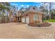 Brick home featuring a circular driveway and meticulously landscaped front yard at 130 Stonewall Beach Ln, Mooresville, NC 28117