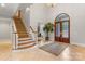 Grand foyer featuring a staircase, tile flooring, and a decorative front door, creating a welcoming entrance at 130 Stonewall Beach Ln, Mooresville, NC 28117