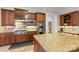 Kitchen featuring stainless steel appliances, granite countertops, tile backsplash, and wood cabinets at 130 Stonewall Beach Ln, Mooresville, NC 28117