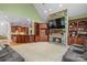 The living room showcases a stone fireplace and built-in wooden shelving, with easy access to the kitchen at 130 Stonewall Beach Ln, Mooresville, NC 28117