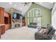 An open concept living room with a stone fireplace, built-in cabinets, and large windows at 130 Stonewall Beach Ln, Mooresville, NC 28117