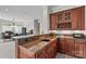 Lovely wet bar features wooden cabinets, granite countertops, and a convenient wine rack at 130 Stonewall Beach Ln, Mooresville, NC 28117