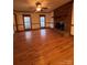 Living room with hardwood floors and brick fireplace at 1409 Trinity Church Rd, Monroe, NC 28112