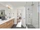 Modern bathroom with dual sinks, large shower, and walk-in closet at 2040 White Cypress Ct # Kh09, Charlotte, NC 28216