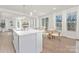 Modern kitchen with white cabinets, quartz countertops, and an island at 2040 White Cypress Ct # Kh09, Charlotte, NC 28216