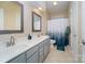 Bathroom with double sinks, shower/tub combo, and updated vanity at 121 Canvasback Rd, Mooresville, NC 28117