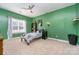 Bright bedroom with green walls, ample closet space, and natural light at 121 Canvasback Rd, Mooresville, NC 28117