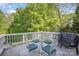 Deck with seating area, grill, and views of the wooded backyard at 121 Canvasback Rd, Mooresville, NC 28117