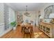 Bright dining room features hardwood floors, a large table, and built-in cabinetry at 121 Canvasback Rd, Mooresville, NC 28117