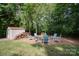 Relaxing firepit area with seating and wood storage shed nearby at 121 Canvasback Rd, Mooresville, NC 28117