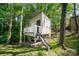 Charming elevated playhouse with slide and deck in wooded setting at 121 Canvasback Rd, Mooresville, NC 28117