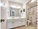 Spacious bathroom features double sinks, large mirror, and a bathtub with shower at 16840 Rudence Ct, Charlotte, NC 28278