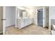 Bathroom featuring double vanity with tile floor, and open doorways at 16840 Rudence Ct, Charlotte, NC 28278