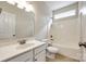 Bright bathroom features a white vanity, toilet, and a shower-tub combo at 16840 Rudence Ct, Charlotte, NC 28278