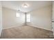 Bedroom with neutral carpet, a large window, and a ceiling light at 16840 Rudence Ct, Charlotte, NC 28278