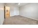 Comfortable bedroom with a ceiling fan, neutral carpet, and an ensuite bathroom at 16840 Rudence Ct, Charlotte, NC 28278