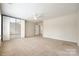 Bright bedroom featuring carpet, ceiling fan, and large mirrored closet at 16840 Rudence Ct, Charlotte, NC 28278