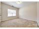 Cozy bedroom with neutral carpet, a bright window, and neutral walls at 16840 Rudence Ct, Charlotte, NC 28278