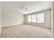 Spacious bedroom with neutral carpet, ceiling fan, and a sunny window at 16840 Rudence Ct, Charlotte, NC 28278