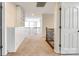 Upstairs hallway with carpet, white railings, and built-in cabinets and shelving at 16840 Rudence Ct, Charlotte, NC 28278