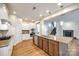 Modern kitchen with stainless steel appliances, granite countertops, and a kitchen island at 16840 Rudence Ct, Charlotte, NC 28278