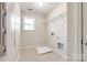 Unfinished laundry room with tiled floors, a window, and a wire shelf at 16840 Rudence Ct, Charlotte, NC 28278