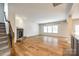 Open-concept living room featuring a stone fireplace and staircase at 16840 Rudence Ct, Charlotte, NC 28278