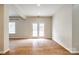 Spacious living room area with double doors, a large window, and a wood floor at 16840 Rudence Ct, Charlotte, NC 28278