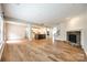 Bright living room with a fireplace, hardwood floors, and a seamless flow into the kitchen at 16840 Rudence Ct, Charlotte, NC 28278