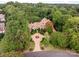 Aerial view of a luxurious house on a tree-lined lot at 4231 Fox Brook Ln, Charlotte, NC 28211