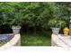 Beautiful backyard featuring lush landscaping and potted plants on a sunny day at 4231 Fox Brook Ln, Charlotte, NC 28211