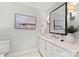 Modern bathroom with white vanity, large mirror, and elegant decor at 4231 Fox Brook Ln, Charlotte, NC 28211