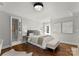 Cozy bedroom with queen bed, hardwood floors and neutral wall tones at 4231 Fox Brook Ln, Charlotte, NC 28211