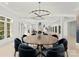 Grand dining room with large round table and statement chandelier at 4231 Fox Brook Ln, Charlotte, NC 28211