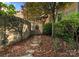 Charming exterior with stone wall, iron gate, and beautiful landscaping at 4231 Fox Brook Ln, Charlotte, NC 28211