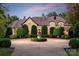 Stunning stone house with circular driveway and manicured landscaping at 4231 Fox Brook Ln, Charlotte, NC 28211