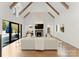 Spacious Gathering room featuring exposed wooden beams, fireplace, and sliding glass doors at 4231 Fox Brook Ln, Charlotte, NC 28211