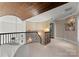 Elegant upper hallway with a curved staircase and stone flooring at 4231 Fox Brook Ln, Charlotte, NC 28211