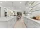 Modern kitchen with gray cabinets, marble countertops, and breakfast bar at 4231 Fox Brook Ln, Charlotte, NC 28211