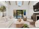 Living room with hardwood floors, fireplace, and view of pool at 4231 Fox Brook Ln, Charlotte, NC 28211