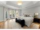 Spacious main bedroom with king bed, access to private balcony and neutral decor at 4231 Fox Brook Ln, Charlotte, NC 28211