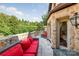 Private stone patio with red furniture and wooded views at 4231 Fox Brook Ln, Charlotte, NC 28211