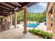 Inviting pool area with covered patio and dining furniture at 4231 Fox Brook Ln, Charlotte, NC 28211