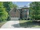 Two-story brick home with a driveway and mature trees at 7954 Rolling Creek Ct, Charlotte, NC 28270