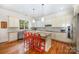 Modern kitchen with white cabinets, granite countertops, and island at 7954 Rolling Creek Ct, Charlotte, NC 28270