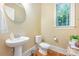 Convenient powder room with pedestal sink and toilet at 7954 Rolling Creek Ct, Charlotte, NC 28270