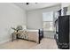 Cozy bedroom features neutral walls, plush carpet, a twin bed, and natural light from a large window at 145 Yellow Birch Loop, Mooresville, NC 28117