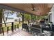 Large covered porch with seating and lake view at 664 Stonemarker Rd, Mooresville, NC 28117