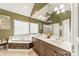 Large bathroom with double vanity, corner soaking tub, and large mirror at 7954 Bay Pointe Dr, Denver, NC 28037